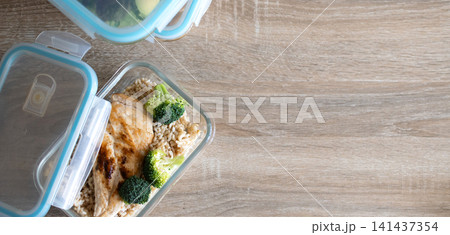 Grilled chicken breast with brown rice and broccoli in glass meal prep container. 141437354