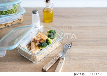 Grilled chicken breast with brown rice and broccoli in glass meal prep container. Grilled chicken breast with brown rice and broccoli in glass meal prep container. 141437355