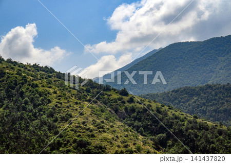 Beautiful mountainous terrain with lush vegetation and clear weather Beautiful mountainous terrain with lush vegetation and clear weather 141437820