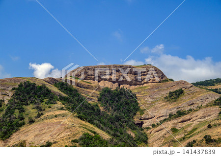 Sunny view of arid mountains with exposed rock strata Sunny view of arid mountains with exposed rock strata 141437839
