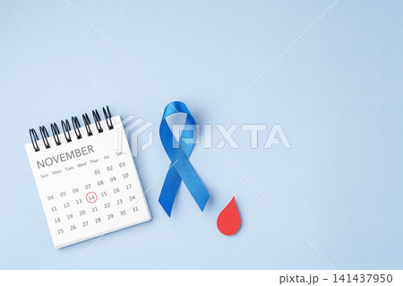 World Diabetes Day concept, November 14 calendar with Blue ribbon with a red blood drop on light blue background World Diabetes Day concept, November 14 calendar with Blue ribbon with a red blood drop on light blue background 141437950