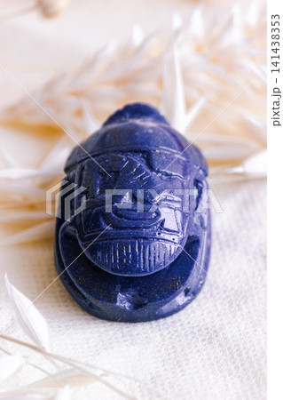 Front view close up of blue lapis lazuli scarab beetle stone carving. Front view close up of blue lapis lazuli scarab beetle stone carving. 141438353