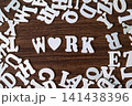 WORK word with heart symbol spelled with letter tiles on scattered letters wooden background, employment and career concept 141438396