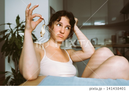 young woman holding remains pear young woman holding remains pear 141438401