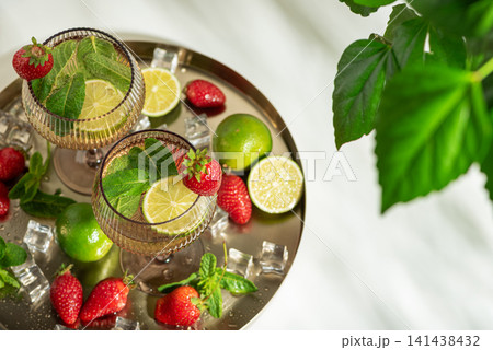 Refreshing strawberry mojito cocktails with lime and mint 141438432