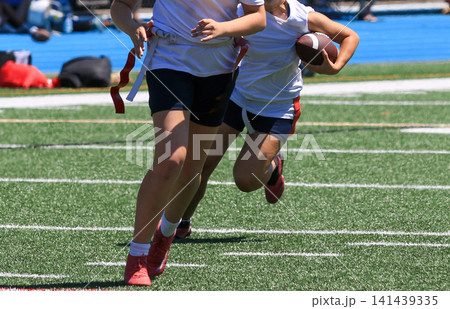 Girls Running on Field During Flag Football Match Clase Up Girls Running on Field During Flag Football Match Clase Up 141439335