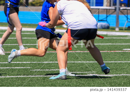 Players Engage in Flag Football Match on Sunny Day Players Engage in Flag Football Match on Sunny Day 141439337