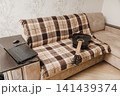 Acoustic guitar beside a laptop and smartphone at home 141439374
