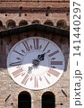 Torre dell'Orologio, Stone Bell Tower (Campanile) topped with brick arch and clock with roman numerals in Lucca, Italy 141440297