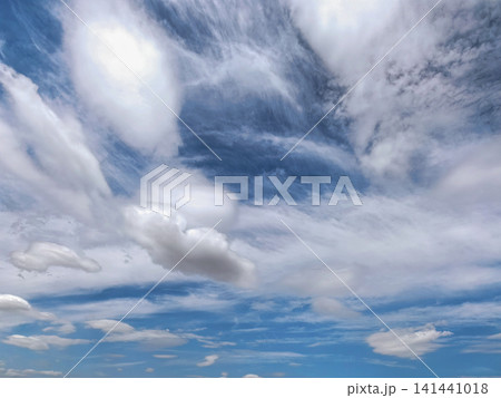 Dramatic White Clouds Across Deep Blue Summer Sky Dramatic White Clouds Across Deep Blue Summer Sky 141441018