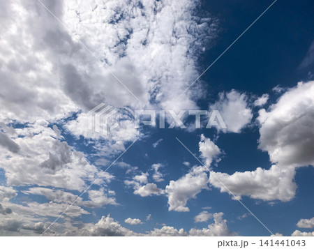 Blue Summer Sky with Scattered White Cumulus Clouds Blue Summer Sky with Scattered White Cumulus Clouds 141441043