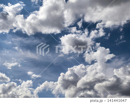 Bright Blue Sky Framed by White Cumulus Clouds Bright Blue Sky Framed by White Cumulus Clouds 141441047