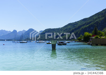 Sailboats on Lake Wolfgangsee in the Salzkammergut, illustrating scenic lake tourism in Austria and classic alpine summer vibe. Sailboats on Lake Wolfgangsee in the Salzkammergut, illustrating scenic lake tourism in Austria and classic alpine summer vibe. 141442386
