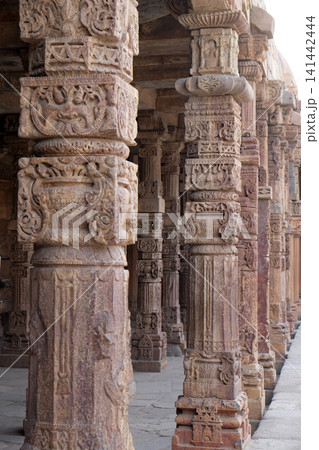 Columns with stone carving in courtyard of Quwwat-Ul-Islam mosque, Qutub Minar complex, Delhi, India Columns with stone carving in courtyard of Quwwat-Ul-Islam mosque, Qutub Minar complex, Delhi, India 141442444