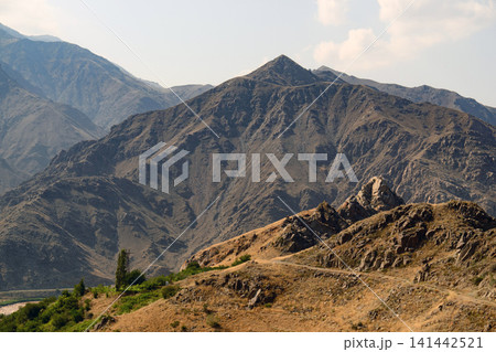 Rugged mountain peak with dry earth tones Rugged mountain peak with dry earth tones 141442521
