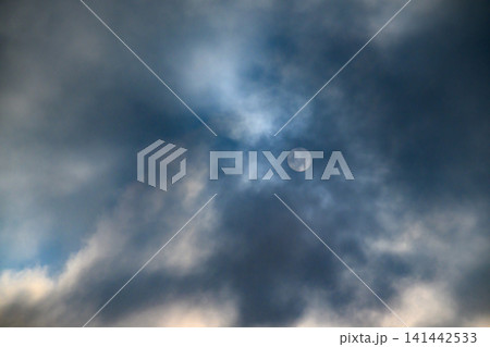 Dramatic sky with moon partially hidden by clouds 141442533