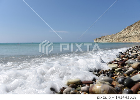 Pissouri beach with sea foam and rocky shoreline, Cyprus 141443618