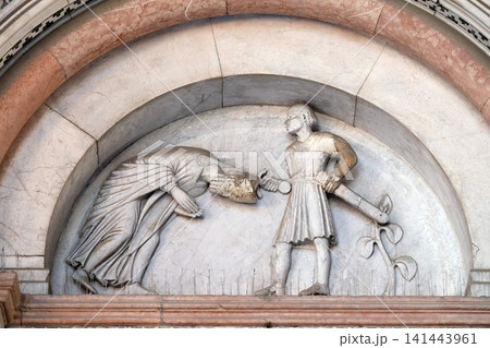 The right portal of the Cathedral of St Martin in Lucca. Lunette depicts the Beheading of Saint Regulus, Lucca, Italy. The right portal of the Cathedral of St Martin in Lucca. Lunette depicts the Beheading of Saint Regulus, Lucca, Italy. 141443961