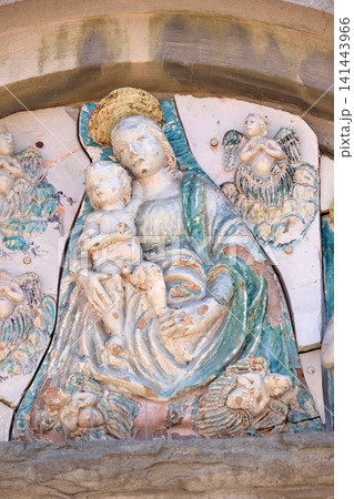 Virgin Mary with baby Jesus on the portal of the Saint Joseph church in Lucca, Italy 141443966