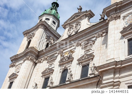 Baroque Facade and Bell Tower of Salzburg Cathedral against Blue Sky with Clouds in Salzburg, Austria Baroque Facade and Bell Tower of Salzburg Cathedral against Blue Sky with Clouds in Salzburg, Austria 141444031