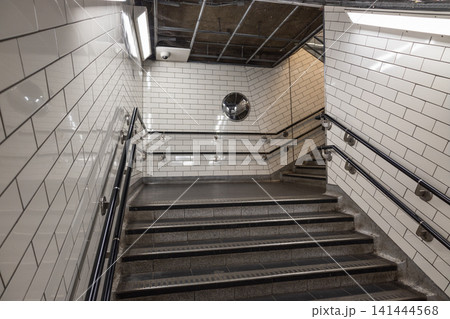 Subway station staircase with white tiled walls 141444568