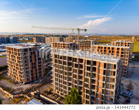 Construction of residential buildings in urban area during daytime Construction of residential buildings in urban area during daytime 141444772