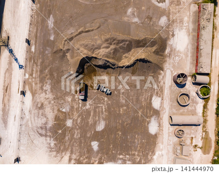 Construction site with heavy machinery and earth moving on a clear day in an urban area Construction site with heavy machinery and earth moving on a clear day in an urban area 141444970