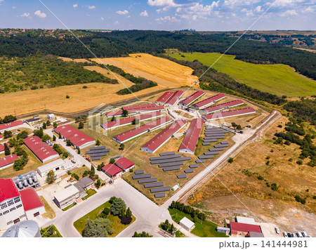 Aerial view of a farm with buildings and fields in the countryside on a sunny day Aerial view of a farm with buildings and fields in the countryside on a sunny day 141444981