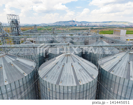 Agricultural storage facility with large silos in a rural area under a cloudy sky Agricultural storage facility with large silos in a rural area under a cloudy sky 141445051