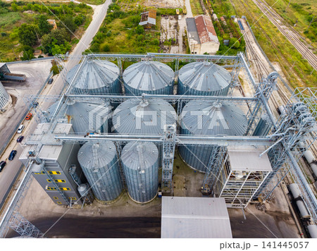 Grain storage facility with silos and surrounding landscape in a rural area during a clear day 141445057