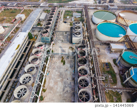 Industrial site with large tanks and equipment located in a manufacturing area during daylight hours 141445069