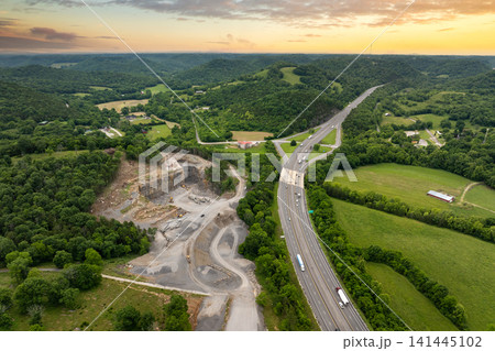 Industrial gravel quarry. Open pit mining site of limestone materials extraction for construction industry Industrial gravel quarry. Open pit mining site of limestone materials extraction for construction industry 141445102