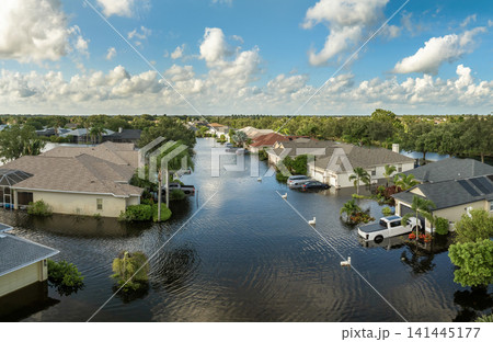 Flooded cars and houses from hurricane rainfall water in Florida residential community. Aftermath of natural disaster in USA south Flooded cars and houses from hurricane rainfall water in Florida residential community. Aftermath of natural disaster in USA south 141445177