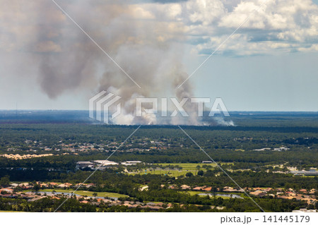 Flames from controlled burn managed by firefighters near community in Florida countryside Flames from controlled burn managed by firefighters near community in Florida countryside 141445179