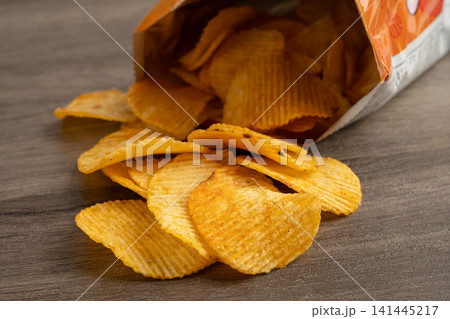 Potato chips , delicious BBQ seasoning spicy for crips, thin slice deep fried snack fast food. 141445217