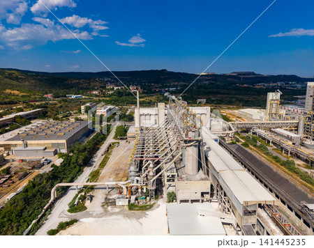 Industrial facility located in a rural area with equipment and structures for manufacturing during bright daylight Industrial facility located in a rural area with equipment and structures for manufacturing during bright daylight 141445235