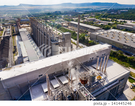 View of an industrial area with large buildings and equipment in the daytime showing production and manufacturing activities 141445246