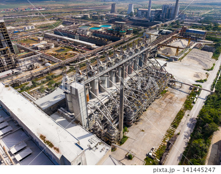 Industrial site with large structures and machinery viewed from above during daytime 141445247