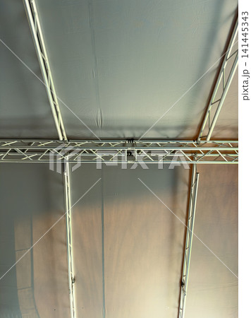 Ceiling structure seen at an event space during daytime creates a simple and clean view of the framework above Ceiling structure seen at an event space during daytime creates a simple and clean view of the framework above 141445343