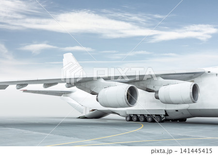 Loading a white big heavy cargo airplane. The rear cargo compartment is open Loading a white big heavy cargo airplane. The rear cargo compartment is open 141445415