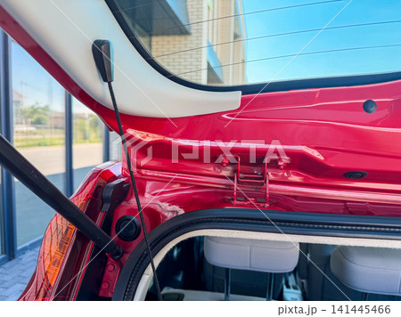 View of the rear hatch of a car showing the interior and the design of the hatch area during a bright day at a parking lot 141445466
