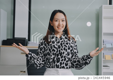 Confident asian business woman standing in modern office Confident asian business woman standing in modern office 141445946