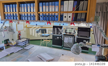 Interior view of ships bridge navigation station with operational equipment and modest christmas decorations tinsel bows for remote home workplace morale concept 141446109