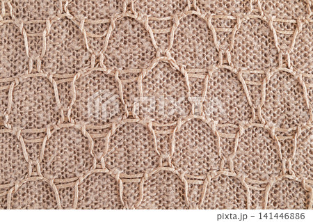 Beige woven jute knit with macrame honeycomb pattern and natural rope texture for decor Beige woven jute knit with macrame honeycomb pattern and natural rope texture for decor 141446886