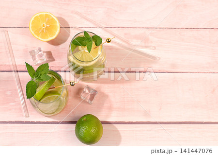 Refreshing summer drink, homemade lemonade, juice or cocktail with ice, mint, lime, lemon and citrus, a detox diet and weight loss concept, a restaurant or cafe menu, nonalcoholic mojito for energy Refreshing summer drink, homemade lemonade, juice or cocktail with ice, mint, lime, lemon and citrus, a detox diet and weight loss concept, a restaurant or cafe menu, nonalcoholic mojito for energy 141447076