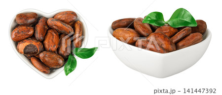 cocoa beans in ceramic bowl isolated on white background. Top view. Flat lay cocoa beans in ceramic bowl isolated on white background. Top view. Flat lay 141447392