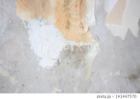 Aged wall showing multiple layers of old wallpaper and plaster before restoration work begins. Aged wall showing multiple layers of old wallpaper and plaster before restoration work begins. 141447570