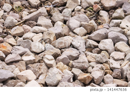 Decorative crushed stone pile with soft neutral tones for garden and outdoor paths. Decorative crushed stone pile with soft neutral tones for garden and outdoor paths. 141447636