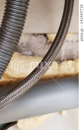 Flexible hose with a metal braided sheath. Flexible hose with a metal braided sheath. 141447716