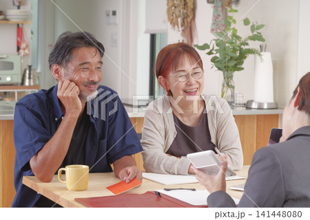 年金受給の説明を受ける熟年夫婦 年金受給の説明を受ける熟年夫婦 141448080